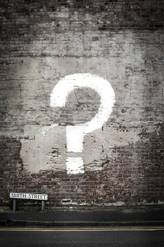 image of a brick wall with a question mark painted on it with a little street sign in the bottom left corner that says Smith Street, to conceptualize the idea of big life questions