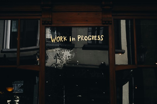image words on a window that say work in progress to symbolize a new approach to defining recovery